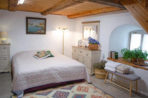 a bedroom with a bed and a table and a mirror at Tôlluste Villa in Tõlluste