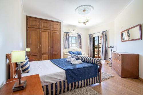 a bedroom with a bed and a couch in a room at Monte das Palmeiras by Algarve Holidays in Loulé