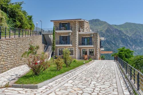 a house on a hill with a stone road at Lithorama Granitsa mountain rooms in Granitsa