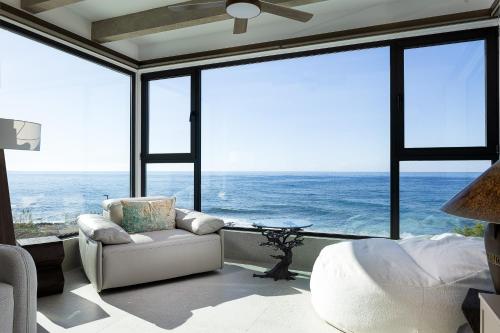 a bedroom with a large window view of the ocean at Moonlight Villas Calypso - Sleek Coastal Living by etouri in Koutsourás
