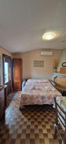 a bedroom with a bed and a table and a chair at Tertium Home in Telti