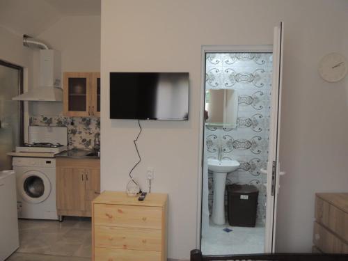 a kitchen with a tv on a white wall at Agmashenebeli house 3 in Mtskheta