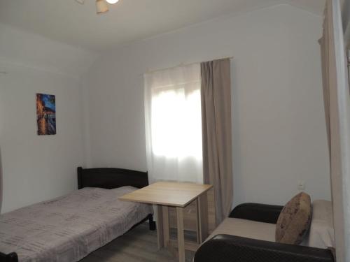 a bedroom with a bed and a table and a chair at Agmashenebeli house 3 in Mtskheta