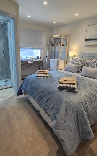 a bedroom with a large bed with towels on it at Wayside Cottage Gairloch Room Accommodation in Gairloch