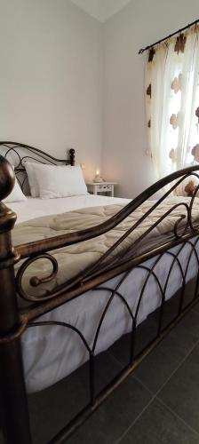 a bedroom with a large bed with white sheets at BlueHouse III in Palekastron