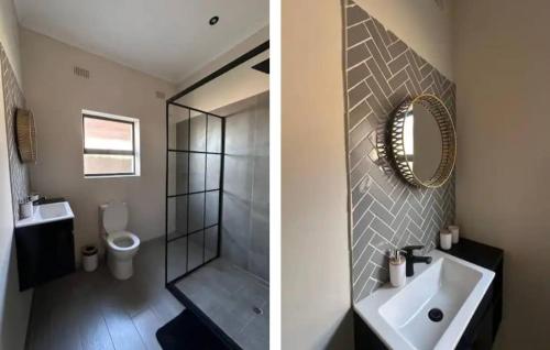 a bathroom with a sink and a toilet and a mirror at Imbarudo Residence in Victoria Falls