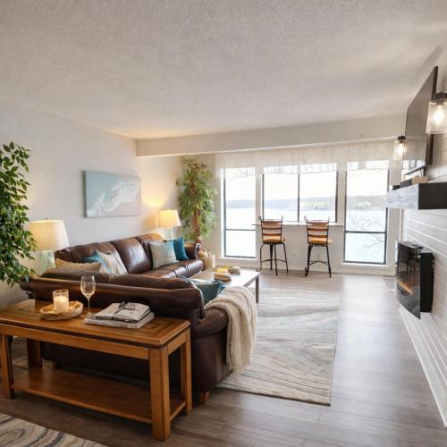 a living room with a couch and a table at Tranquil Retreat - Close to everything you need in Osage Beach