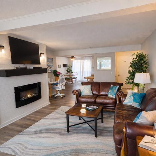 a living room with a couch and a fireplace at Tranquil Retreat - Close to everything you need in Osage Beach