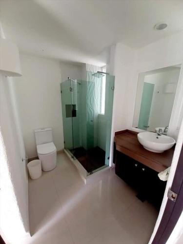 a bathroom with a shower and a sink and a toilet at Suite Club Deportivo in Acapulco