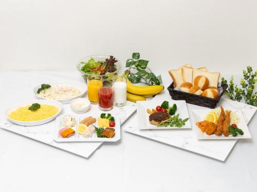 a table filled with different types of food at Tabist Ishinomaki in Ishinomaki