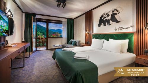 a hotel room with a bed and a television at Alfaresort Palace Chiflika in Chiflik