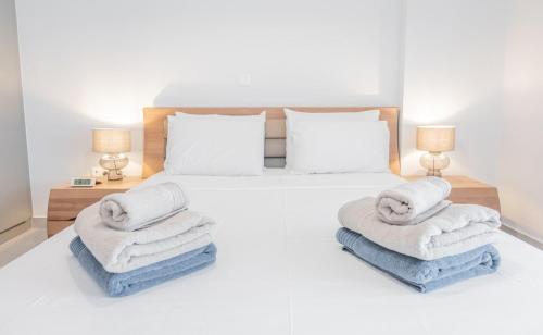 a bedroom with a bed with towels on it at White Haven in Korinthos