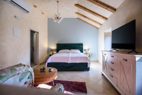 a bedroom with a bed and a flat screen tv at Bottega in Mlini