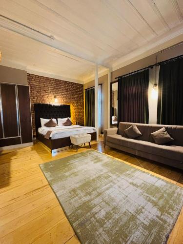 a bedroom with a bed and a couch in a room at Berfinn Hotel Beşiktaş in Istanbul