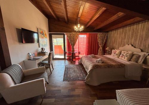 a bedroom with a bed and a desk and a couch at B&B Villa del Sole Relais in Agrigento