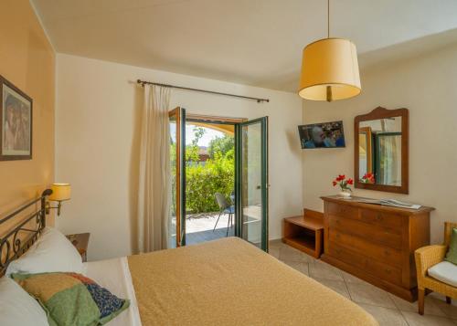 a bedroom with a bed and a dresser and a mirror at Agriturismo Parmenide in Castelnuovo Cilento