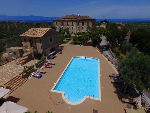 an overhead view of a swimming pool in front of a building at Tenuta Ciminata Greco in Rossano