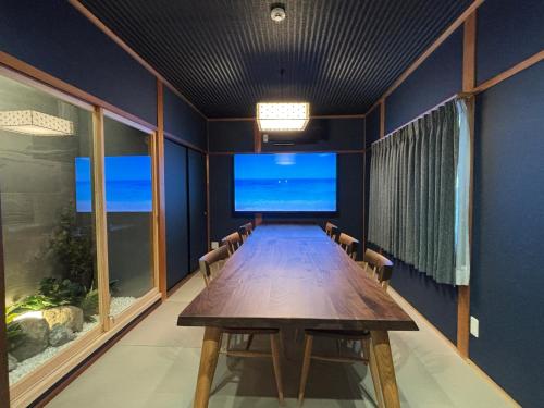 a conference room with a long wooden table and windows at 凪 nagi Awaji in Awaji