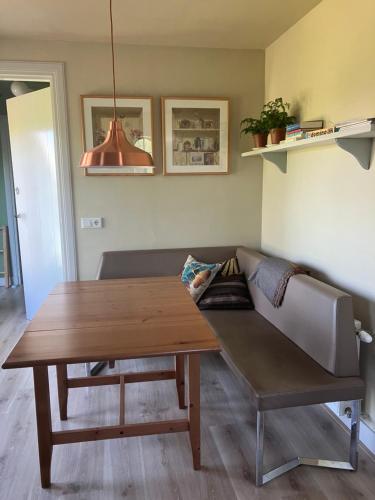 a living room with a couch and a wooden table at Klein Garnwerd 9 in Garnwerd