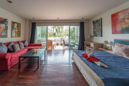 a living room with two beds and a couch at Southern Lanta Apartments in Ko Lanta