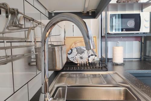 a kitchen with a sink and a faucet at Southern Lanta Apartments in Ko Lanta