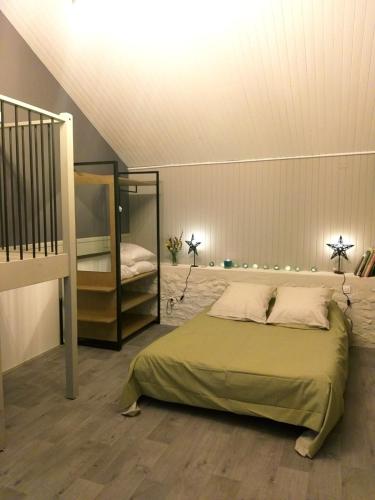 a bedroom with a bed and a ladder and a crib at La Borieta in Labastide-de-Penne