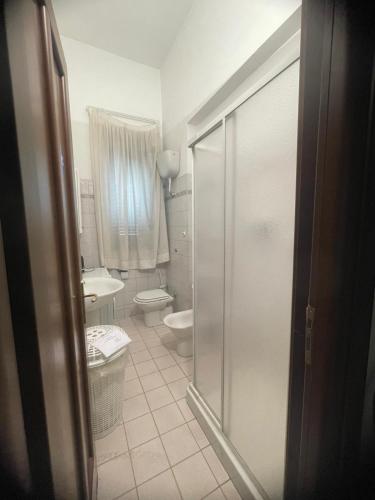 a bathroom with a shower and a toilet and a sink at Mappet B&B in Melito di Porto Salvo