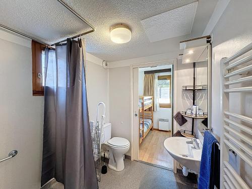 a bathroom with a toilet and a sink at L'Eterlou by Mountain Collection Immobilier in Saint-Chaffrey