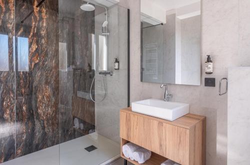 a bathroom with a sink and a shower at The Originals city, Hôtel Harys in Vichy