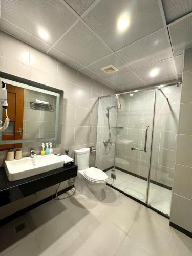a bathroom with a shower and a toilet and a sink at Gllant Villa Hà Nội in Hanoi