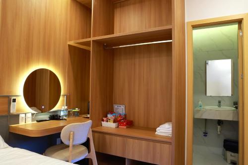a bedroom with a sink and a desk with a mirror at Anna seaview hotel in Phú Quốc