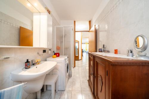 a bathroom with a white sink and a mirror at Casa Ester a due passi dal lago in Germignaga