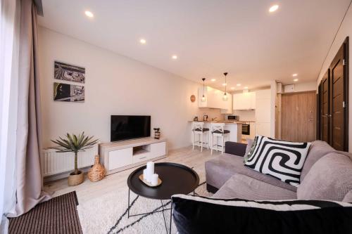 a living room with a couch and a table at King Mindaugas Apartments in Kaunas