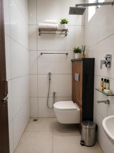 a bathroom with a toilet and a sink at Shri Valli Residency in Palni