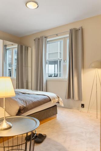 a bedroom with a bed and a table at Exclusive apartment in Lofoten in Svolvær
