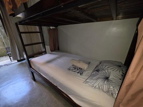 a bedroom with a bunk bed in a room at jbsurf House in Catagnan