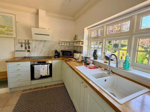 a kitchen with a sink and a counter top at Old Hunstanton luxury by the sea in Hunstanton