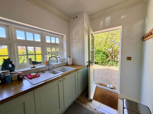 a kitchen with a sink and a window at Old Hunstanton luxury by the sea in Hunstanton