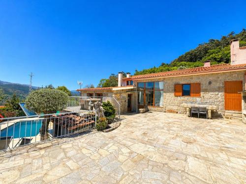 a villa with a swimming pool and a house at Casa da Lage - Piscina privada - Vistas rio - "Gerês" in Geres