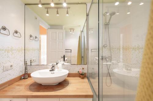 a bathroom with a white sink and a shower at Ducado B104 in Pals