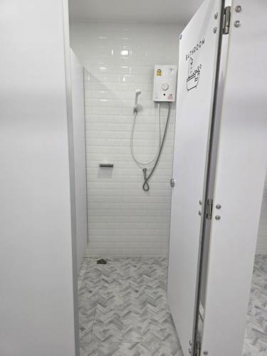 a bathroom with a shower with a hose in it at Near the Beach Cha-Am in Cha Am