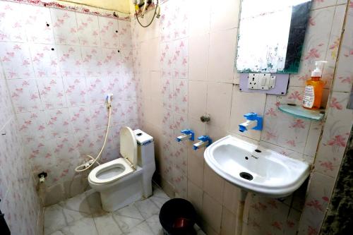 a bathroom with a toilet and a sink at Hotel Hindon Residency "Couple Friendly" in Ghaziabad