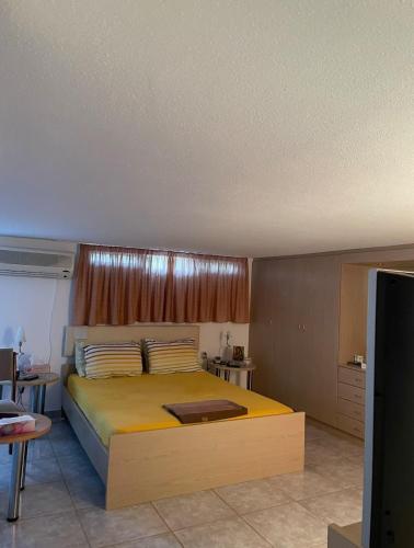 a bedroom with a large yellow bed in a room at Plepi's Seaside Villa in Plépi
