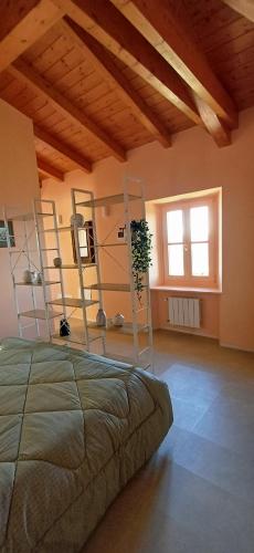 a bedroom with a bed in a room with wooden ceilings at Casa del Moro al Sacro Monte app1 in Varese