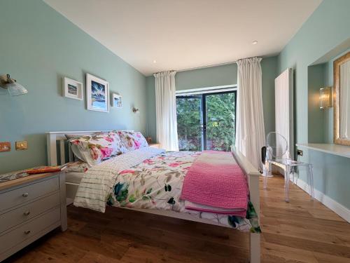 a bedroom with a bed with a dresser and a window at Old Hunstanton luxury by the sea in Hunstanton