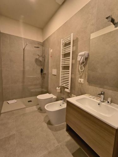 a bathroom with a sink and a toilet and a shower at Hotel Domus Rome in Rome