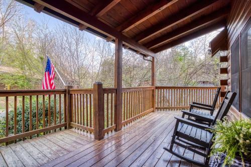 a porch with two chairs and an american flag at Six-Bedroom House in Pigeon Forge
