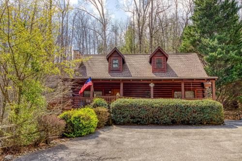 a log cabin with an american flag on it at Six-Bedroom House in Pigeon Forge
