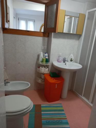 a bathroom with a sink and a toilet and a mirror at Casa Serena 2 in Scanno