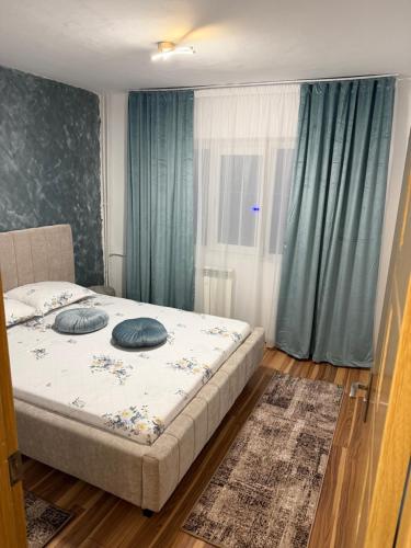 a bedroom with a bed with two pillows on it at Apart1 in Drobeta-Turnu Severin